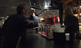 picture of a man wearing black suit in the bar